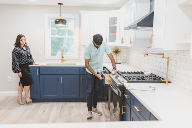 person doing home inspection in kitchen